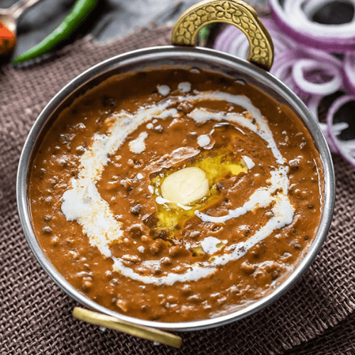 Creamy and rich black lentils slow-cooked with butter